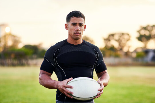 Man, portrait and rugby with ball for outdoor, game or challenge in exercise, wellness and fitness. Male person, athlete and recreation facility in arena for match, sports and training in new zealand - Powered by Adobe