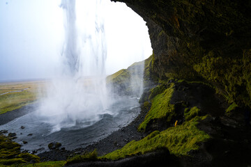 Long waterfall with a rough cliff