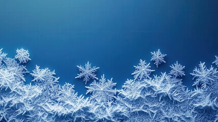 Close-up of intricate ice crystals and snowflakes on a cold blue background, delicate winter frost macro with detailed frozen patterns
