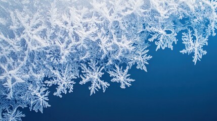 Close-up of intricate ice crystals and snowflakes on a cold blue background, delicate winter frost macro with detailed frozen patterns