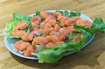salmon slices on green leaves, red fish, ingredient for salad