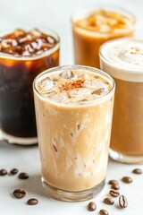 Refreshing iced coffee drinks with creamy variations and coffee beans on table
