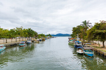 Boat dock at Paraty Bay in Rio de Janeiro, Brazil, where passenger boats await tourists to be taken to nearby islands or other villages.