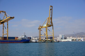 Cranes loading containers at the port of Malaga.......
