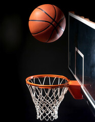 Basketball and Basketball Hoop floating or flying, isolated on a Dark black