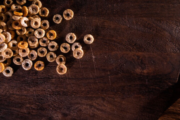 Copy space with round cornflakes on a wooden surface