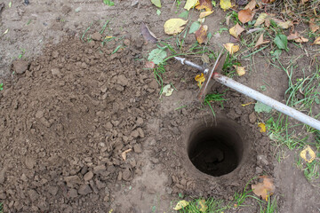 Drilling a hole in the ground with a hand drill