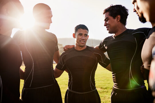 Men, rugby and scrum with team on grass field for game plan, motivation or sport competition. Young, group or football players in huddle with captain for speech, challenge or tournament on stadium - Powered by Adobe
