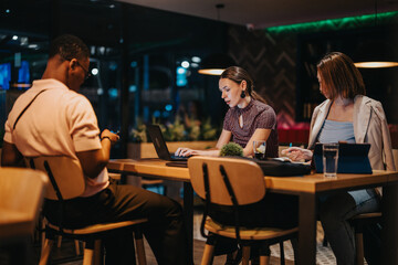 A diverse group of business professionals collaborate in a strategic meeting. The atmosphere is focused as they critically analyze and brainstorm strategies, embodying teamwork and dedication late