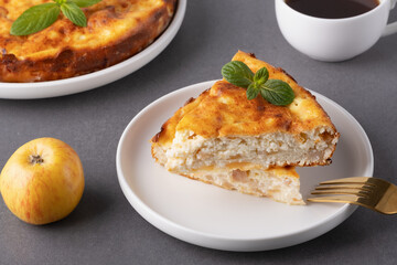 Delicious homemade apple pie served with coffee and garnished with mint leaves on a cozy kitchen table