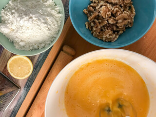 baking preparation with eggs, flour, and walnuts

