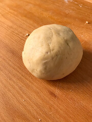 ball of dough on wooden surface
