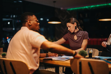 A diverse group of professionals engaged in a brainstorming session at night, focusing on strategic planning and analysis. The atmosphere is collaborative and intense, highlighting teamwork and
