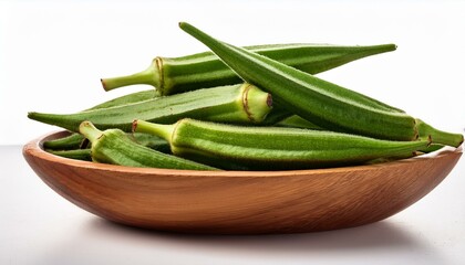 pile of fresh green okra in a wooden bowl isolated on white background