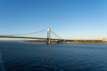 view of Verrazzano-Narrows Bridge over blue water on a sunny day with a clear sky in New York, USA