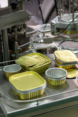 Close-up side view of group of gold coloured metal food preserve packages. Soft focus. Copy space. Container background theme.