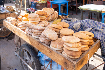Freshly baked traditional flatbread (Khobz) on a cart for sale in the morning in a typical street market of Morocco. 