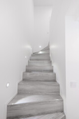 Wooden Modern Stairs and Railing. Upstairs. White Walls, LED Light. Home Interior