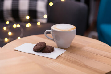 Cozy Coffee and Cookies on Wooden Table at Festive Coffee Shop