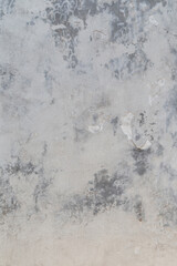 Front view of a cracked, weathered and dirty plastered stone or concrete wall. Abstract high resolution full frame textured background, copy space.