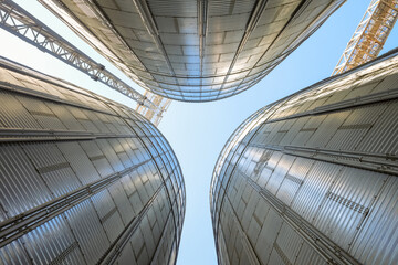 Silo Grain bins view from bottom to top. Grain dryer complex. Granary with loading tower.