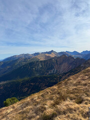 Panoramic views from Mount Giewont, Tatra Mountains, Poland, revealing sweeping landscapes and majestic peaks