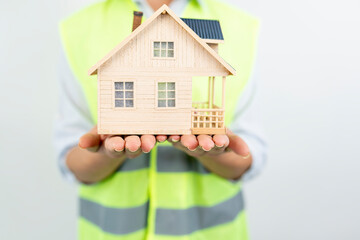 Home inspector woman or engineer holding detached house model