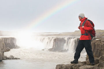 A male Hiker at the Selfoss waterfall on Jökulsá á Fjöllum river near the Diamond Circle...
