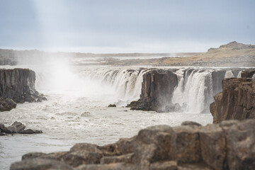 Selfoss waterfall on Jökulsá á Fjöllum river near the Diamond Circle (Demantshringurinn), showcasing cascading water and a rainbow.