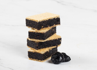 Vegan dessert. Waffles with prunes. Close-up.  White bacckground