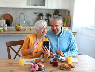 woman man senior couple home mobile phone phone retirement communication breakfast wife husband...