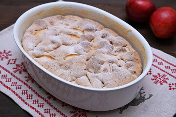 freshly baked apple pie sprinkled with powdered sugar close-up