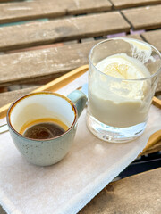 Cup of espresso with a glass of creamy affogato on a wooden table