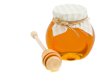 honey in glass pot and stick