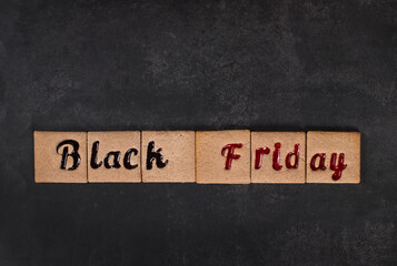 Black Friday. Square cookies with red and black marmalade filling in the form of the words Black Friday. Dark background. Top view