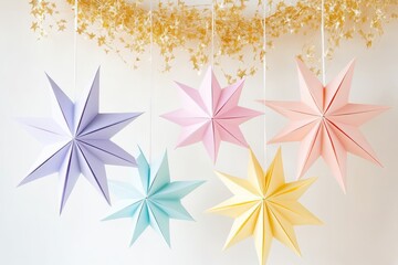 Colorful paper stars hanging with soft lights in a festive holiday setting.