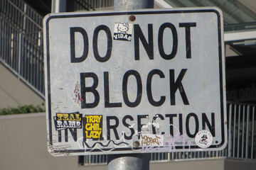 Los Angeles, California, USA, June 21, 2022: LA Road Sign. Closeup of a white Do Not Block Intersection road sign on the side of a street.