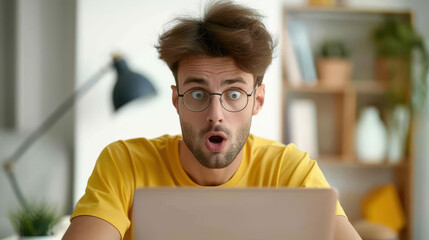 A man sits at home, eyes wide with shock as he reads shocking news on his laptop, expressing pure surprise.