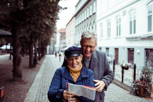 Senior mature couple exploring city with map - Powered by Adobe