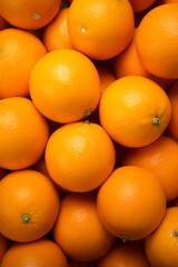 A close-up shot of a group of fresh, ripe oranges, with a focus on their vibrant orange color and smooth, glossy texture.