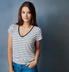 Casual, fashion and portrait of woman in studio on gray background with stripes on relaxed outfit. Clothes, cute and wardrobe with confident person on mockup space to model trendy clothing style