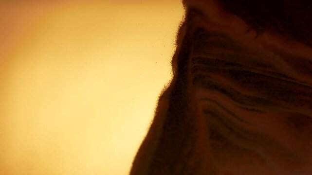 Little grains of sand moving in abstract slow motion. 