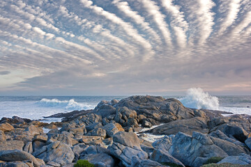 Stones, beach horizon and ocean for travel, holiday or vacation in nature with clouds outdoor. Sea...