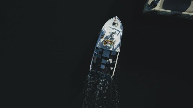 Aerial view of commercial lobster fishing vessel as it approaches and docks at picturesque Lockeport harbour, Nova Scotia, Canada.  MAX QUAL PRORES422HQ Transcode of 4K H.265 D-CINELIKE capture.