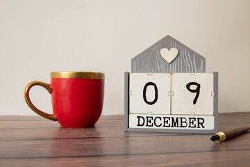 Closeup surface white wooden calendar with black 9 december word