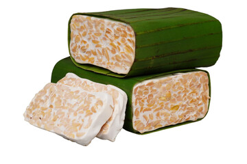 Two blocks of banana-leaf-wrapped raw tempeh and a few slices isolated transparent