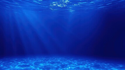 Obraz premium Seamless underwater background of deep blue ocean waves with flowing micro particles and shining light rays, micro particles, shining
