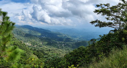 green mountains with big white clouds and blue sky, mountains cpm abundant trees