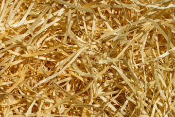 Packaging material. Straw for packing fragile items. Top view of natural color shredded wood excelsior for filling inside box when sending package