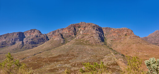 Outdoor, wild and view of mountain in nature, holiday location and peace in sustainable landscape. Earth, countryside and hills to explore on vacation, remote adventure and environment for travel